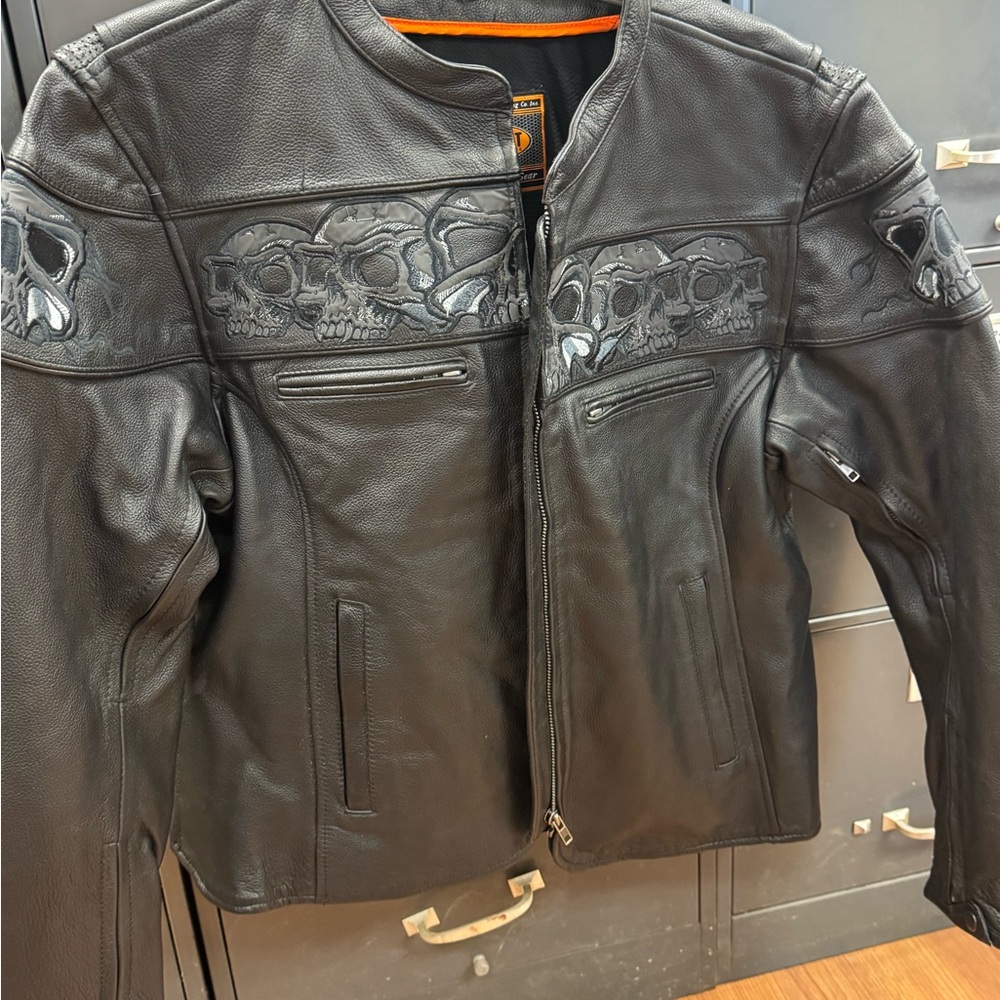 Black Leather Biker Jacket with Skull Design. The skulls have reflection